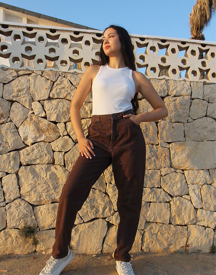 Mom jeans in brown. High rise. Zipper fly. Front and back pockets. Tapered leg. Size EU 40 / UK 12 Actual measurements - 30"(76cm) waist - 40"(102cm) hips - 30.5"(77cm) inner leg - 13"(33cm). Composition - 100% Cotton Condition - Excellent. Sustainability - Vintage Handpicked, repaired and ready to wear. This is an original vintage item, not new and minor signs of wear and age are expected, we will highlight any major flaws. Model is a size UK 6/8 and is 5'7" tall Brown Straight Leg Jeans With Belt Loops, Brown Jeans With Belt Loops For Fall, Brown Fall Jeans With Belt Loops, Brown Jeans With Belt Loops, Brown Full Length Jeans With Belt Loops, Brown Cotton Jeans With Belt Loops, High Rise Brown Cargo Pants, High Waist Brown Pants With Five Pockets, Mid-rise Brown Cotton Jeans