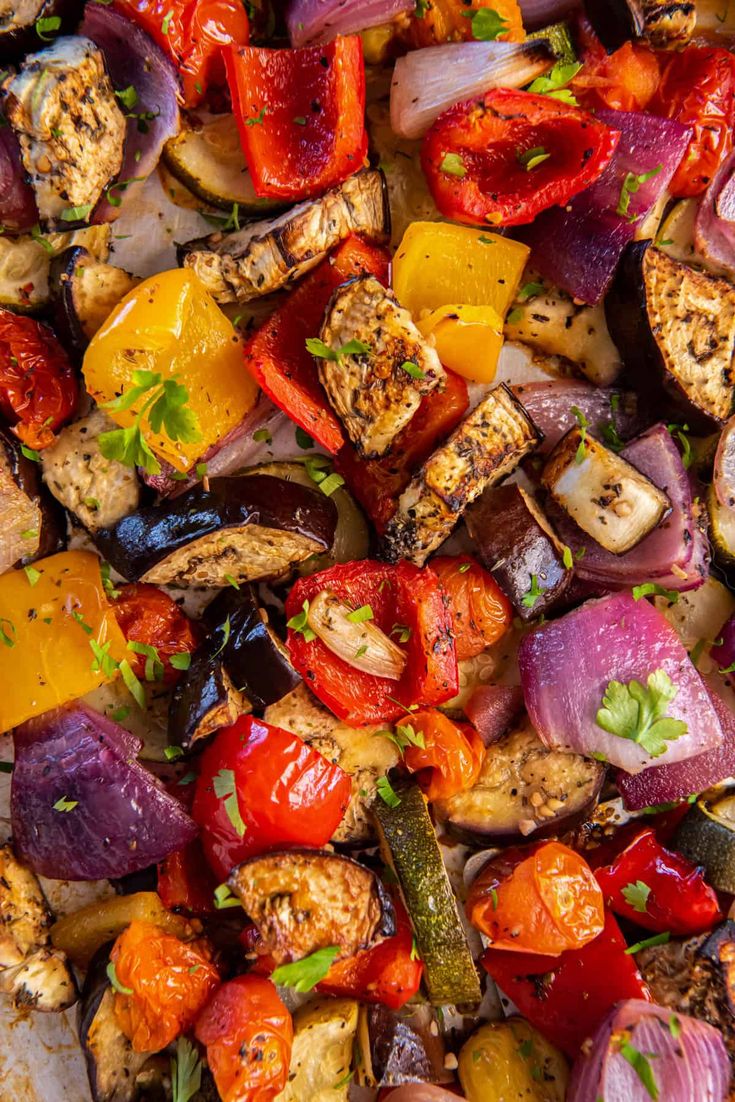 an assortment of grilled vegetables on a sheet pan