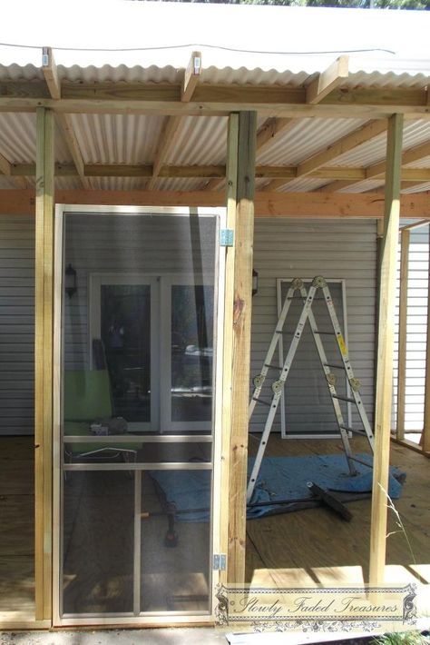 a house being built with wooden framing and glass doors