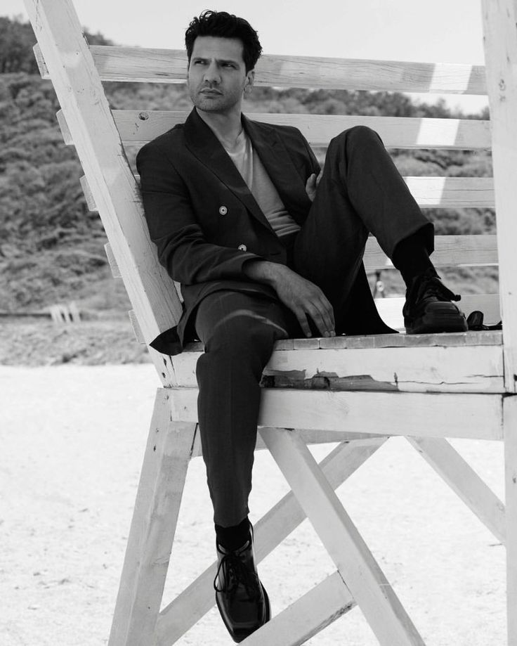 a man sitting on top of a wooden chair