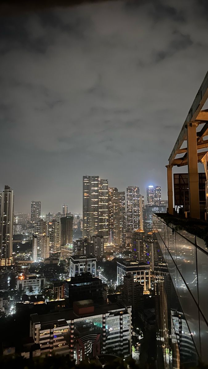 the city skyline is lit up at night