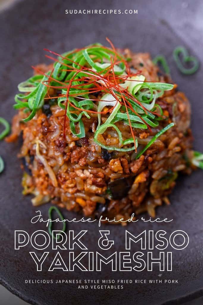 an image of pork and miso yakimeshi on a black plate with green sprouts