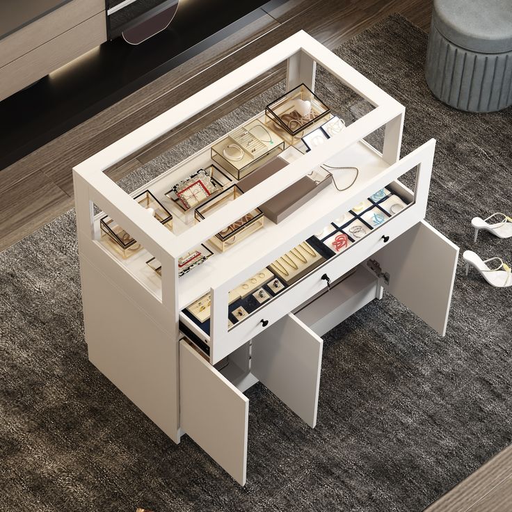 a white table with drawers underneath it on the carpeted floor next to a coffee table