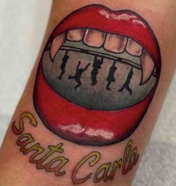 a close up of a person's foot with a tattoo on it that says santa carol