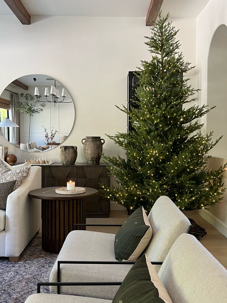 a living room filled with furniture and a christmas tree in the middle of the room