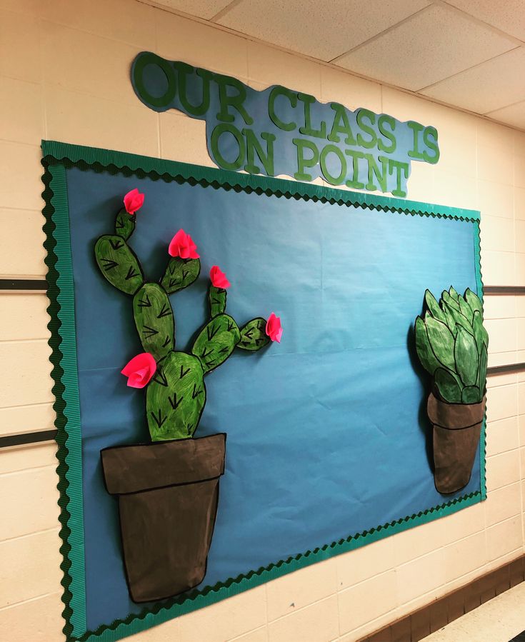 a bulletin board with cactuses on it and the words our class is on point