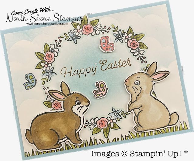 an easter card with two rabbits and flowers