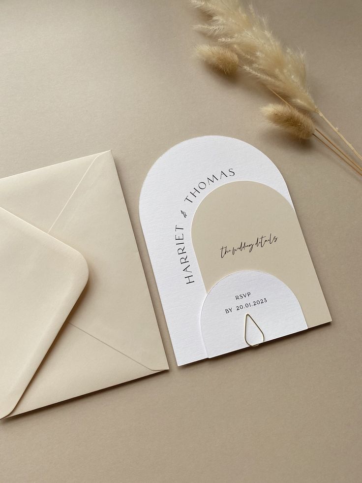 an envelope with a card and some feathers