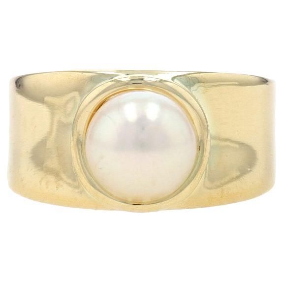 Size: 7 1/4 Sizing Fee: Up 2 sizes for $60 or Down 3 sizes for $50 Metal Content: 14k Yellow Gold Stone Information Cultured Pearl Size: 7.7mm Style: Solitaire Features: Slightly contoured shoulders Measurements Face Height (north to south): 13/32" (9.9mm) Rise Above Finger: 3/8" (9.3mm) Weight: 7.5 Grams Stamps: 14k, maker's mark (worn, partial) Condition: Pre-Owned Professionally cleaned, polished, and tested to guarantee metal content. Elegant Rings With Tension Setting And Thick Band, Modern Yellow Gold Pearl Ring For Anniversary, Elegant Jewelry With Thick Band Tension Setting, Modern Yellow Gold Pearl Ring For Formal Occasions, Timeless Gold Rings With High Luster, 14k Yellow Gold High Luster Pearl Ring, Elegant 14k Stamped Thick Band Jewelry, Classic Yellow Gold Rings With High Luster, Classic High Luster Yellow Gold Rings