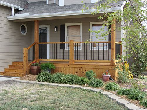 a house with a wooden porch and railing