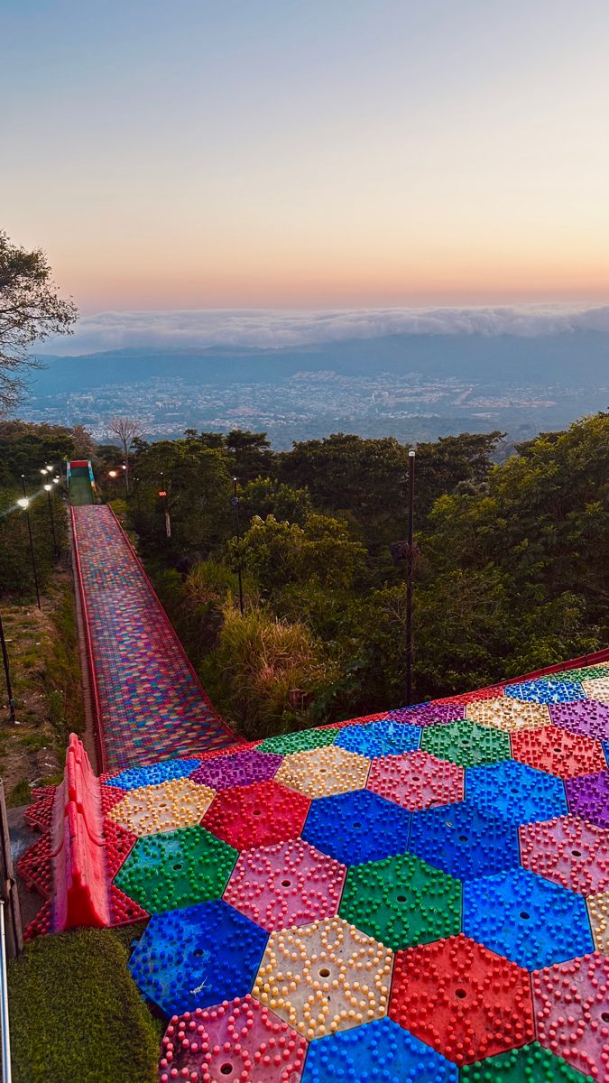 a colorfully designed walkway on top of a hill