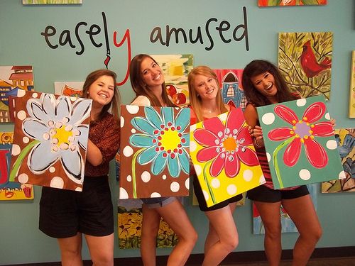 four girls are holding paintings in front of a wall that says, easyy amused