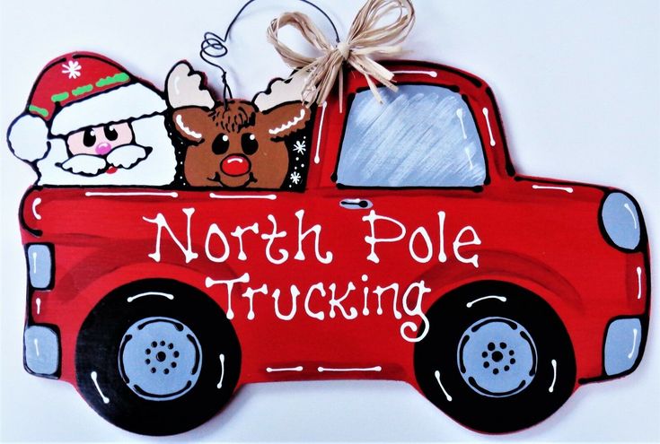 a red truck with santa claus and reindeer on it