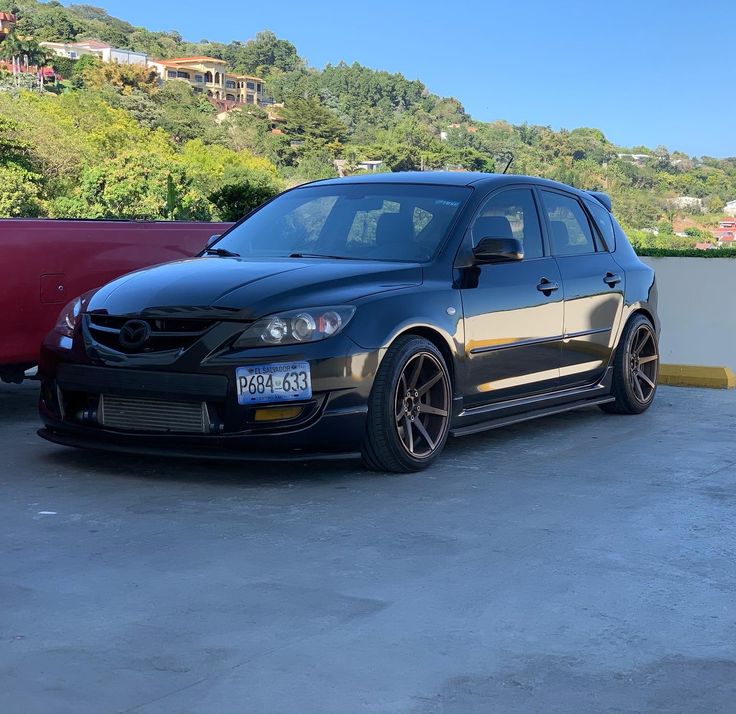 a black car parked next to a red car