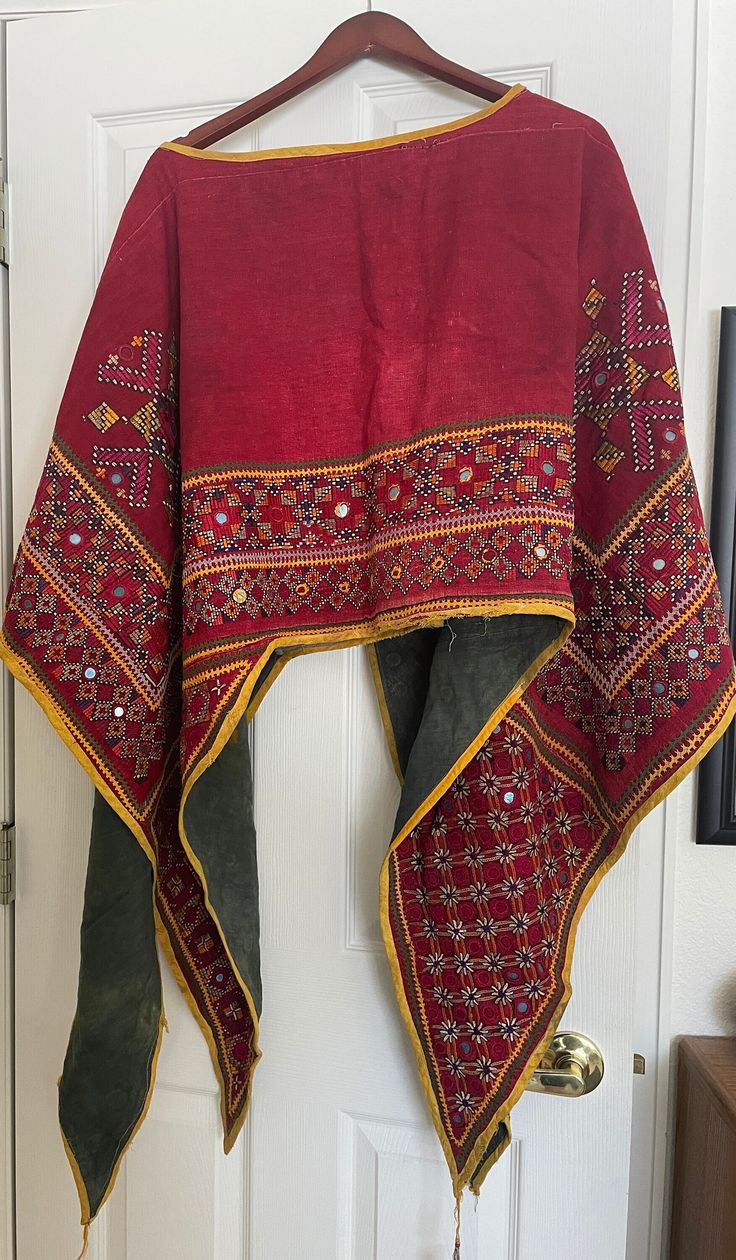 This is a beautifully embroidered vintage shawl poncho in the traditional India Banjara style. Some wear around the neck hole, as pictured, otherwise in great condition. Measures 52" x 80". Bohemian Multicolor Shawl With Embroidered Border, Traditional Red Shawl Poncho, Traditional Shawl With Embroidered Border, Bohemian Shawl With Intricate Multicolor Embroidery, Bohemian Shawl Dupatta With Multicolor Embroidery, Traditional Ceremonial Dupatta Shawl, Folk Style Embroidered Multicolor Shawl Dupatta, Folk Style Multicolor Embroidered Dupatta Shawl, Multicolor Embroidered Folk Shawl Dupatta