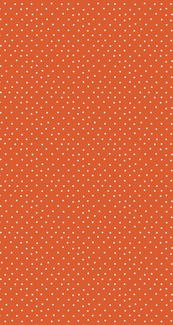 an orange background with white polka dots