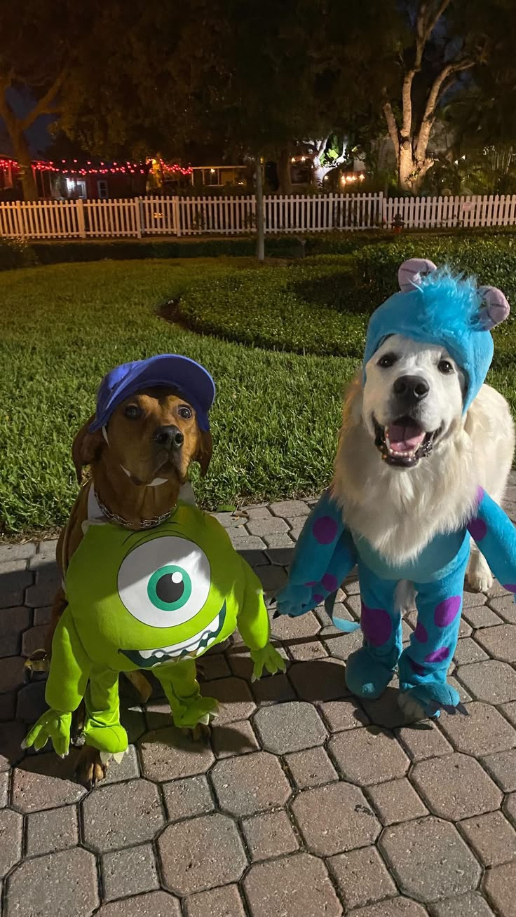 two dogs dressed up as monsters on the sidewalk