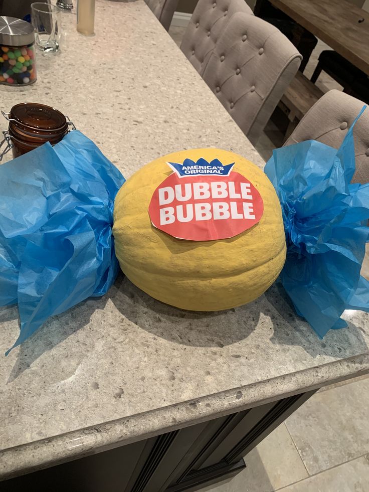 there is a large cheese ball on the counter with blue plastic bags around it that says bubble bubble