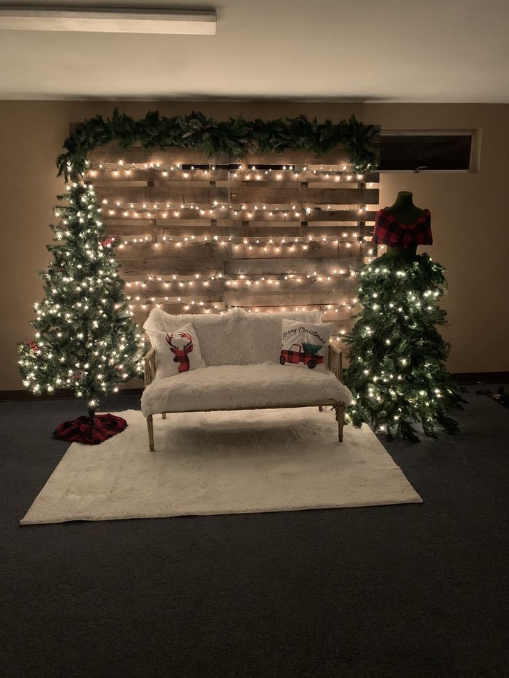 a living room decorated for christmas with lights on the wall and trees in the corner