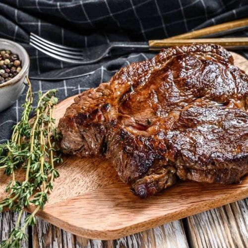 steak on a cutting board with herbs and spices