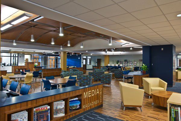 a library with tables, chairs and bookshelves