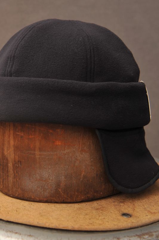 Made in 100% polartec. Tucked away ear flap. Brand: HW Dog & Co. Made in Japan Black Fleece-lined Hats For Winter Sports, Black Hats With Fleece Lining And Ear Flaps, Black Hat With Fleece Lining And Ear Flaps, Winter Six-panel Hat For Outdoor Activities, Travel Hat, Cashmere Beanie, Wide Brimmed, Large Black, Wool Felt