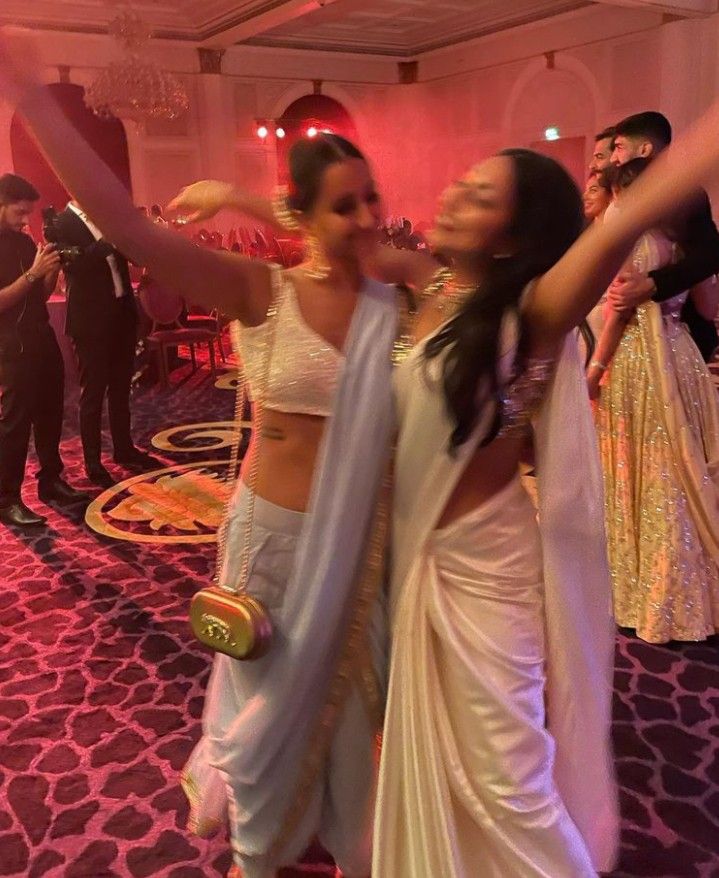 two women in sari dancing on the dance floor