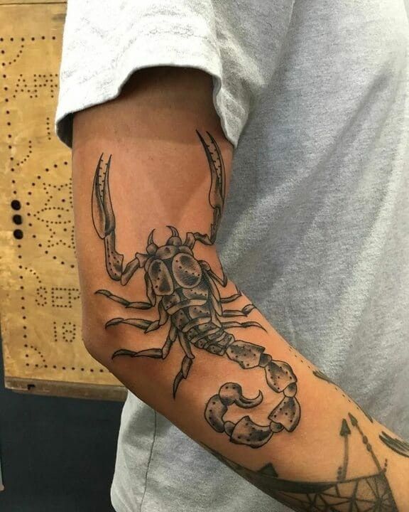 a man with a scorpion tattoo on his arm