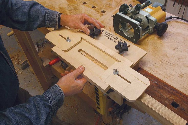 a person working with woodworking tools on a workbench in a shop or workshop