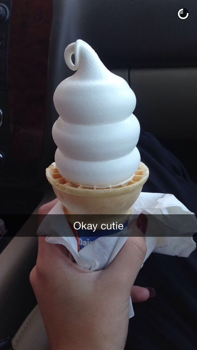 a person holding an ice cream cone in their hand with the caption okay cutie