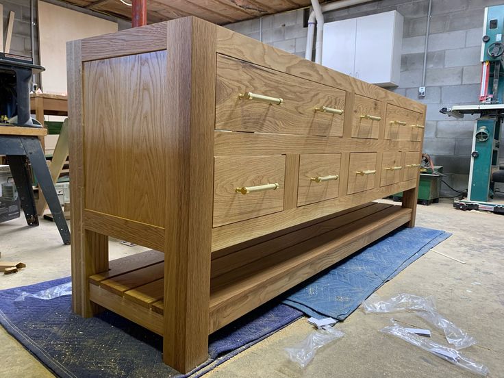 a large wooden dresser sitting on top of a blue mat