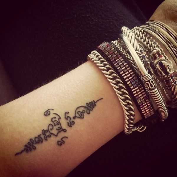 a woman's arm with several bracelets on it and the word love written in cursive writing