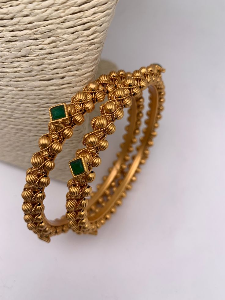 Green Stone Golden Bangles Luxury Elegant Emerald Bangle, Luxury 22k Gold Temple Jewelry Bangle, Luxury Green Fusion Style Bangle, Luxury Gold Bangle With Stone Work, Luxury Green Fusion Bangle, Luxury Green Chandbalis For Diwali, Luxury Gold Plated Chandbalis For Celebration, Luxury Green Chandbalis In Fusion Style, Luxury Green Temple Jewelry Chandbalis