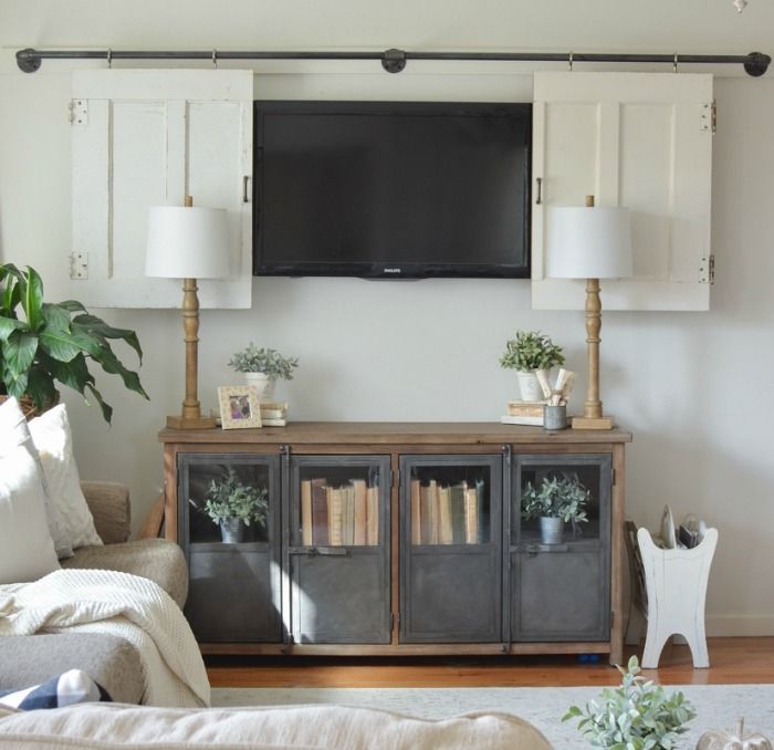 a living room with a tv mounted on the wall