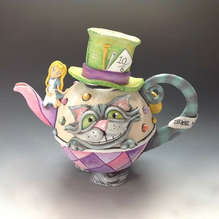 a ceramic teapot with a cat wearing a top hat