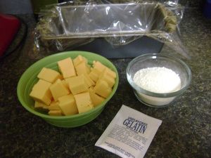 there are many pieces of cheese in the bowl and on the counter next to each other