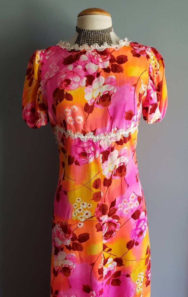 "Such a cool late 60s to early 70s pop art print dress of roses and rose buds in shades of pink, orange, yellow, red and white, a touch of lace trim at neckline and empire waist. No makers or size tags so please compare my hand measurements to a favorite dress of your own. Bust 36-38\", waist 30-32\", hips up to 50\", puff sleeves are 9\" from top of shoulder, closes with a rear center 21\" zipper, total length from top of shoulder to bottom is 56\". In great condition with no flaws or issues, p Vintage Hawaiian Dress, Hand Measurements, Pink Orange Yellow, Pop Art Print, Hip Ups, Hawaiian Dress, Hawaiian Print, Printed Maxi, Rose Print