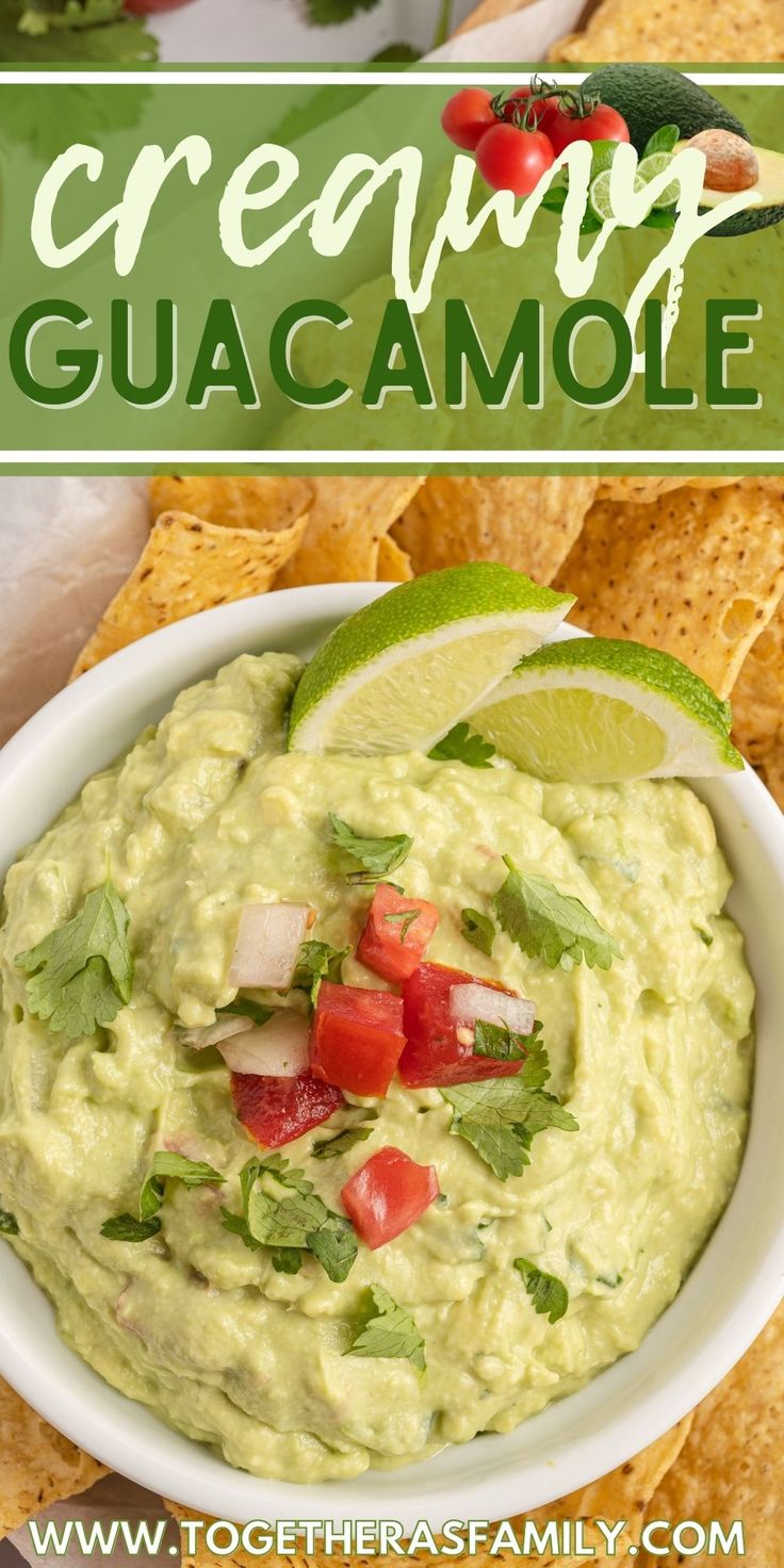 a white bowl filled with guacamole surrounded by tortilla chips and tomatoes