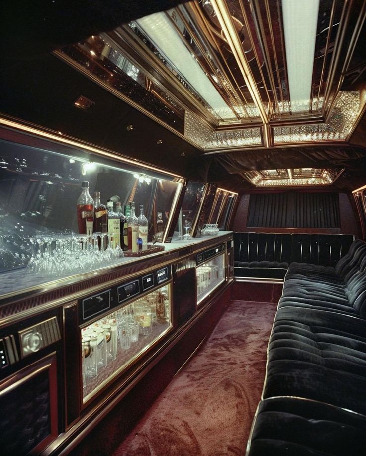 the inside of a limo with several liquor bottles and glasses on it's shelves