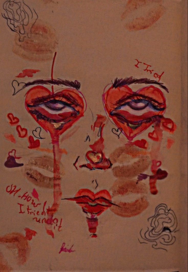 a drawing with red and brown paint on it's face next to another drawing