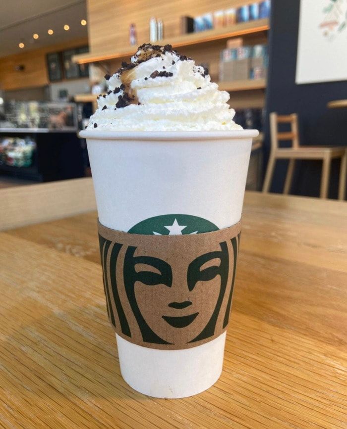 a starbucks cup with whipped cream on top