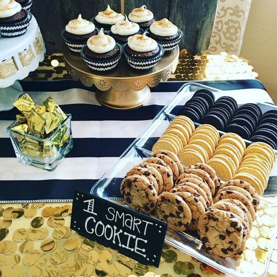 a table topped with lots of cookies and cupcakes