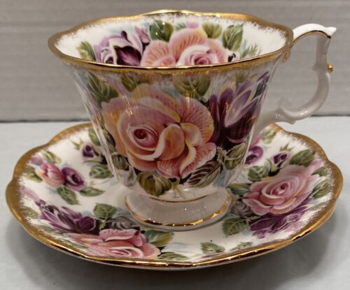 an antique tea cup and saucer decorated with pink, yellow and purple flowers on a white background