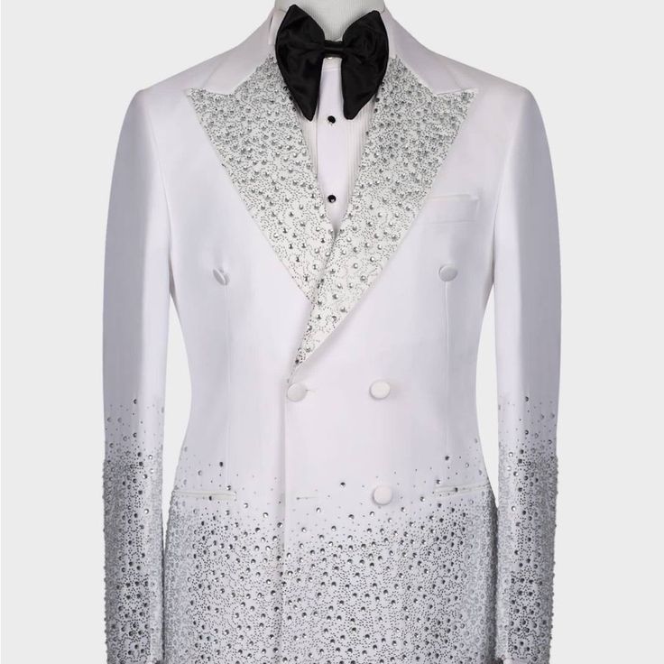 a white tuxedo with black bow tie and sequins