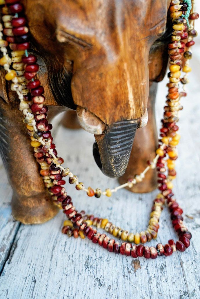 an elephant statue with beads around it's neck