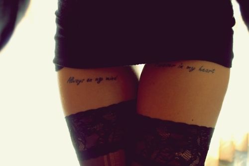 two women's legs with tattoo sayings on their thighs and the words may you be my heart