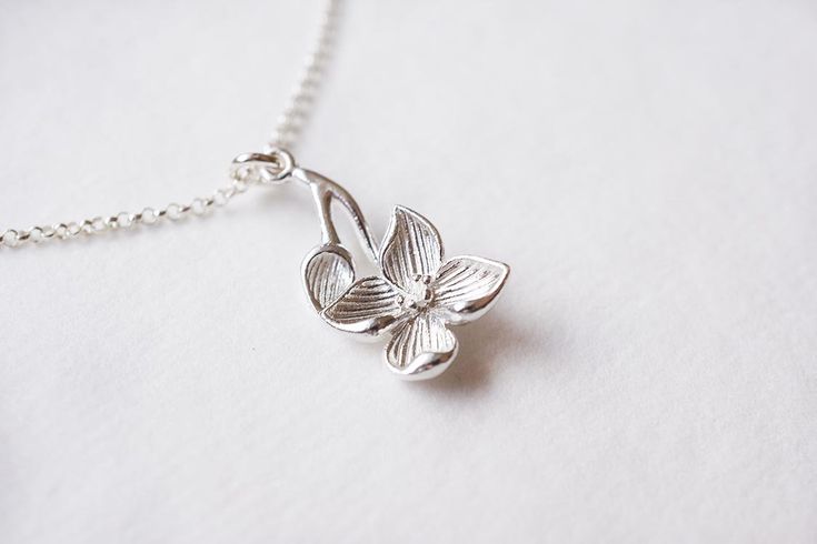 Sterling Silver Dogwood Flower Necklace, No. BSRC023 :*About This Piece*: ♦︎ An elegant recreation of one of spring's loveliest blossoming trees, this sterling silver dogwood blossom pendant is hung on sterling silver rolo chain. The flowering pendant is gorgeous, solid sterling silver. ♦︎ Length - 18 in (45.7 cm) chain ♦︎ Pendant - .47 in (12 mm) x .9 in (23 mm) ♦︎ All items from my shop are packaged in padded cardboard jewelry boxes. Custom gifting options available upon request. ♦︎ Are you lo Delicate Sterling Silver Jewelry For Spring, Spring Delicate Sterling Silver Jewelry, Silver Necklaces For Spring Gift, Silver Necklace For Spring Gift, Elegant Sterling Silver Spring Jewelry, Elegant Sterling Silver Jewelry For Spring, Spring Wedding Sterling Silver Jewelry, Silver Necklaces With Flower Charm For Spring, Spring Gift Silver Necklace