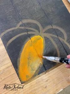 someone is using a paintbrush to paint a piece of art with yellow and gray colors