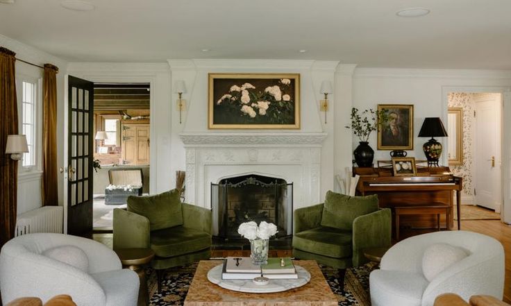 a living room filled with furniture and a fire place in front of a painting on the wall