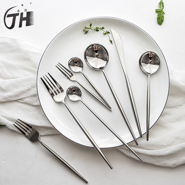 a white plate topped with silverware and spoons